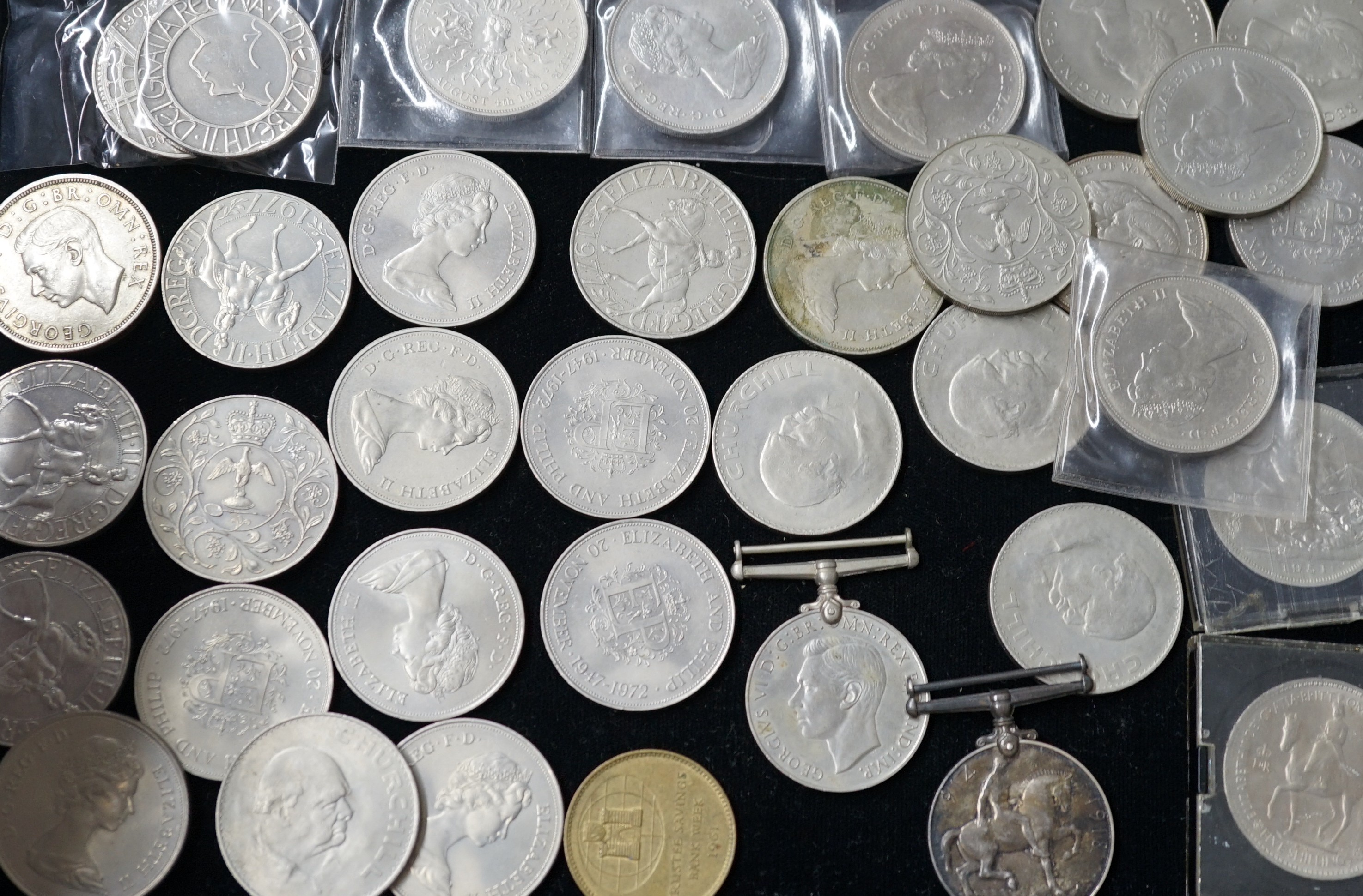 A group of QEII crowns and two medals